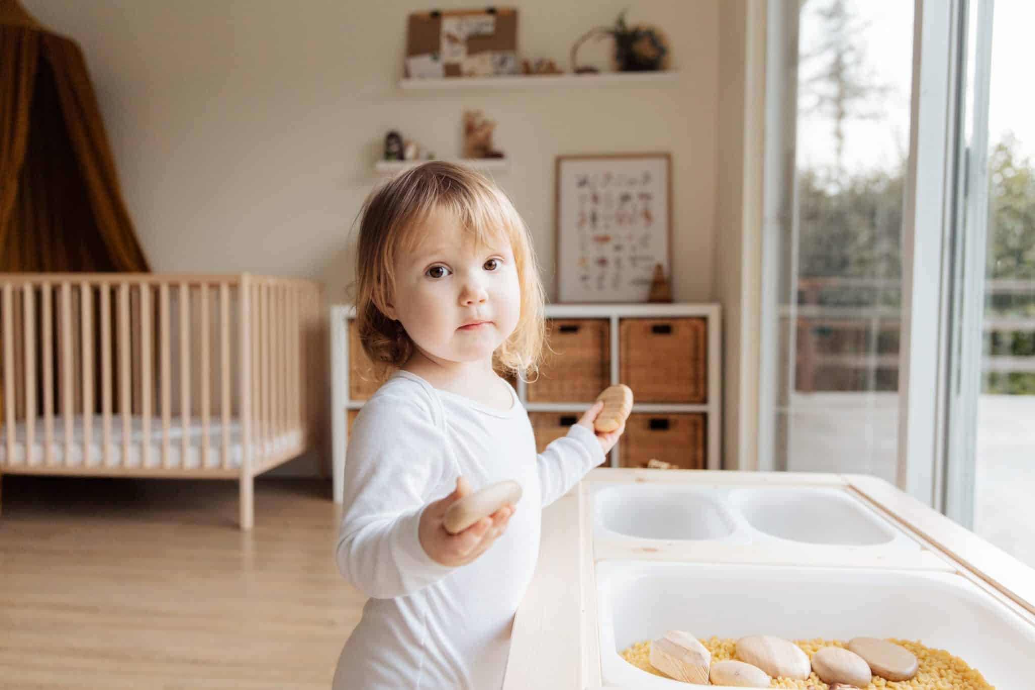 Toddler playing with a sensory box